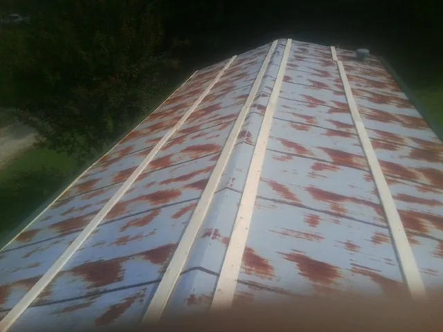 Rusted metal roof panels with new wood purlins before replacement — Storm Damage Roof Repair in Anthony by Roofing Brothers